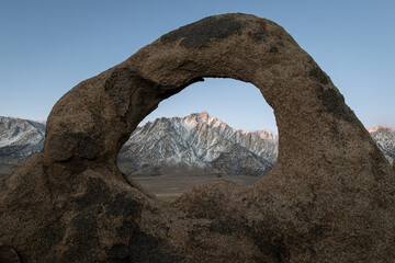 The Whitney Arch rock formation in the Alabama Hills frames Mt. Whitney and the Sierra Nevada range