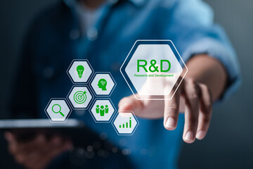 R and D, Research and Development concept. Businessman use tablet with R and D icons on virtual screen. Manage costs more efficiently, Research and development of business science technology.