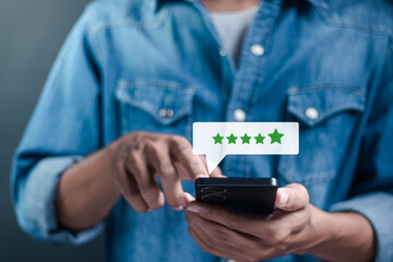Businessman use smartphone to give excellent five-star ratings on virtual screen. Service experience rating, Satisfaction feedback review, good quality most. Customer satisfaction survey concept.