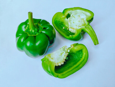 Capsicum sweet bell pepper whole and cut halved vegetable food ingredient shimla mirch bellpeppers closeup view image stock photo