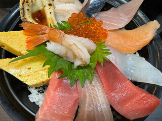 Sashimi japanese food in black plate on wooden table