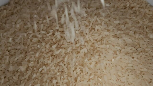 rice that flows down from rice milling machine.There's a real sound.
