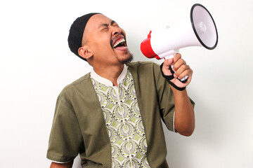Excited Indonesian Muslim man in koko and peci shouts into a megaphone, announcing Ramadan sales...