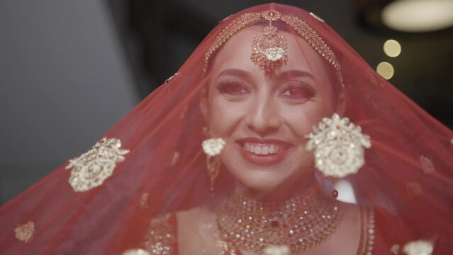 Lovely Indian Bride In Her Traditional Wedding Red Veil. Close Up Shot