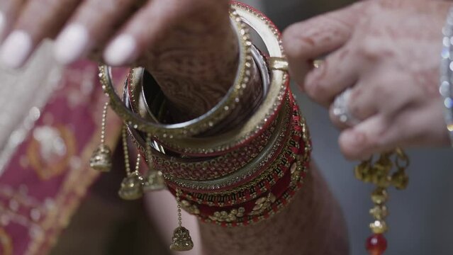 Indian Bride Wearing Bangles Accessories During Wedding Day. Closeup Shot
