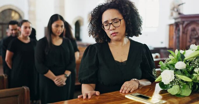 Coffin, funeral and sad woman with death, grief and people at burial ceremony in church with flowers. Memorial service, casket and person mourning, respect and depression with farewell of family