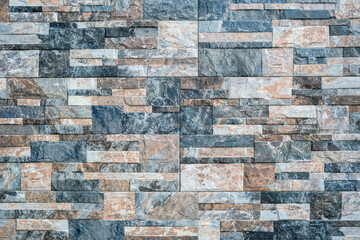 Background from a wall made of small stone tiles