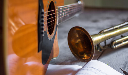 a guitar, a trumpet and the musical notes of a new melody