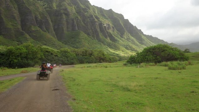 Following motor bikes on Hawaiian dirt road - wide, steady cam shot