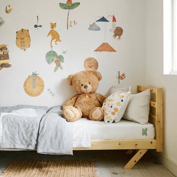 Teddy bear on single wooden bed in natural kid's bedroom