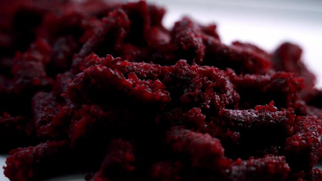 Extreme close up of beet pulp spinning on a rotating plate to make chocolate muffins vegan vegetarian cake