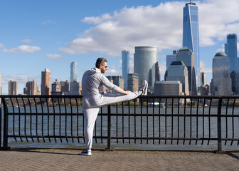 Athlete stretching to improve flexibility. Athlete stretching muscles and preparing for workout. Stretching routine of athlete outdoor. Athlete stretching his muscles after running. workout stretch