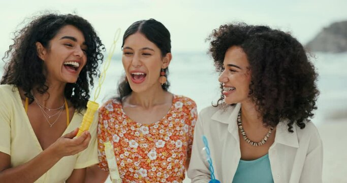 Women, friends or blowing bubbles on beach for a fun holiday vacation for memory on trip together. Smile, laughing or happy people at sea for wellness, support or playful games with love, joy or care