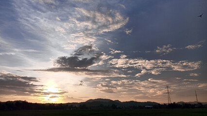 Beautiful view of clouds and sky in the afternoon with a hill