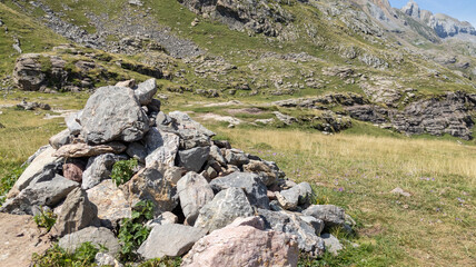 Fototapeta na wymiar pile of stones in a pyramid at the foot of the mountains