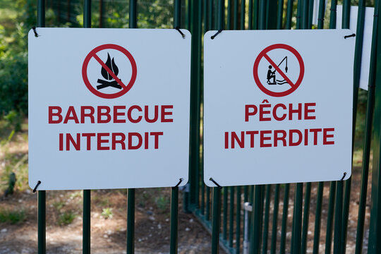 barbecue interdit panel and peche interdite sign french text means barbecue forbidden and fishing prohibited in park lake city