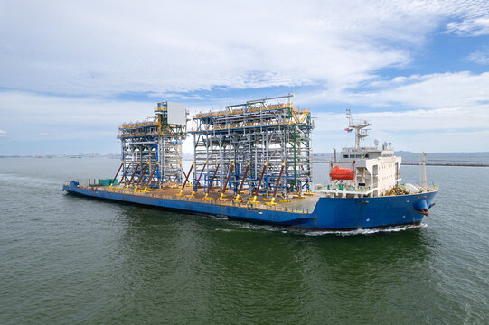 Top view Logistics and transportation large cargo ship Transporting loads of oil rig parts  Oversized cargo transportation