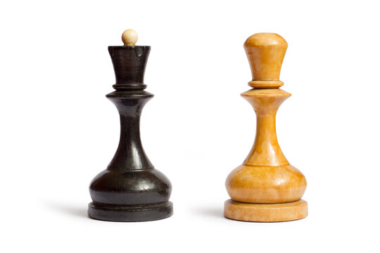 Black and white chess pieces on a white background. Old wooden chess pieces.