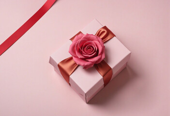 design concept with pink rose flower and gift box on colored table background top view