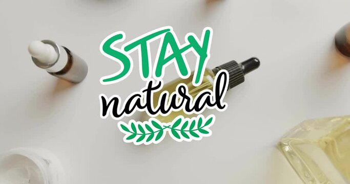 Animation of stay natural text and leaf logo over organic beauty creams and oils on white