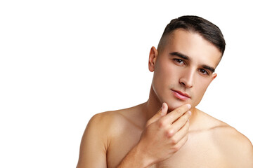 Young attractive brunet guy with perfect skin touching chin on white background