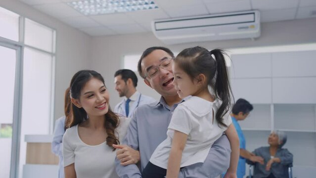Asian family patient walking through corridor in the hospital ward.