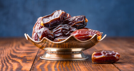 Dried delicious date fruit on wooden background	