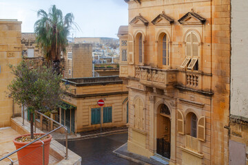 Narrow street of ancient city Rabat with traditional maltese houses built of limestone, Victoria, Malta