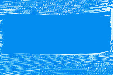  clear stripe on soap foamed window glass, blue background