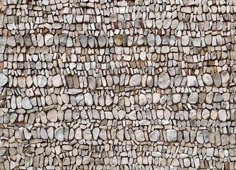 Mosaic made of white, beige and gray  pebbles on concrete backdrop. Detail. Background and texture.	