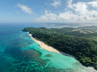 Aerial view of turquoise clear water with boats and waves on white sand. Puka Shell Beach. Boracay, Philippines.