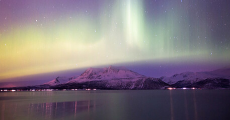 Aurora Borealis in Tromso, Norway in front of the Norwegian fjord 