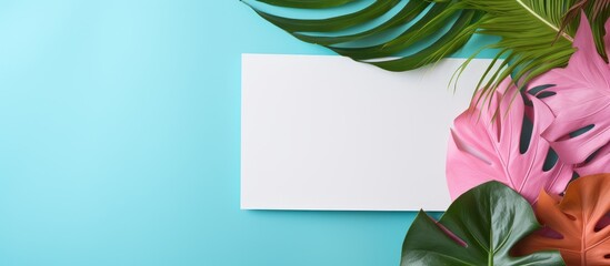 Tropical Paradise: Lush Green Leaves Frame a Tranquil Blank Paper on Blue Background
