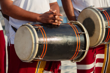 Drummers playing instruments on the beach shore