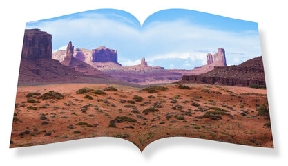 The Monument Valley in Utah–Arizona state with the red earth desert in the foreground - The...