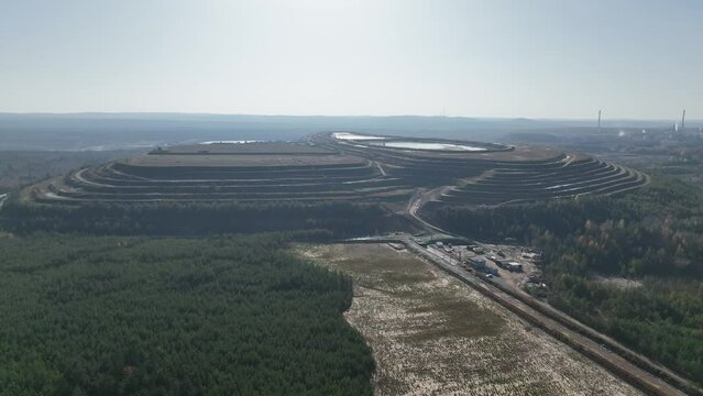  Settling tanks and clarifiers are on wastewater treatment plant. Industrial coal mine, abstract sendimentation tank of mine in Poland. Industrial lake Aerial drone photo view