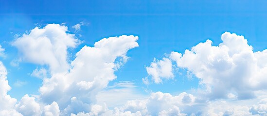 Majestic Plane Soaring Amidst Fluffy Clouds in the Vast Blue Sky - obrazy, fototapety, plakaty