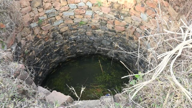 Old water well.  It is common to see these wells in the fields of India.  Earlier, it was used for farming. This well is made of stones.