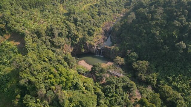 Stunning Vuc Hom Waterfalls nestled in pristine tropical setting surrounded by rainforest in Vietnam's Phu Yen province