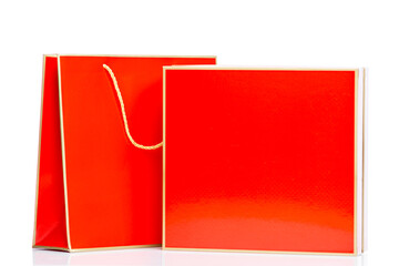 Red gift box with package. Surprises, gifts and congratulations on holidays. Space for text. Isolated on a white background.