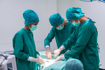 Medical team doing critical operation. Group of surgeons in operating room with surgery equipment...