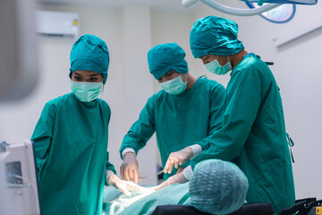 Medical team doing critical operation. Group of surgeons in operating room with surgery equipment at hospital.