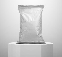 Foil food package, on a white octagonal pedestal