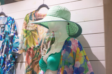 Female mannequin in blue beach hat closeup