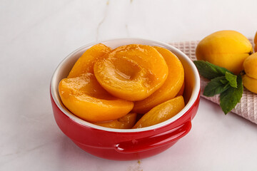 Few canned aprocots in the bowl