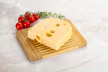 Maasdam cheese brick over board