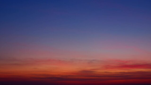 A time lapse video captures the ethereal beauty of the sky at sunrise, where clouds drift seamlessly against a backdrop of evolving colors. Stock footage. Time-lapse. Cloud background. 4K HDR.

