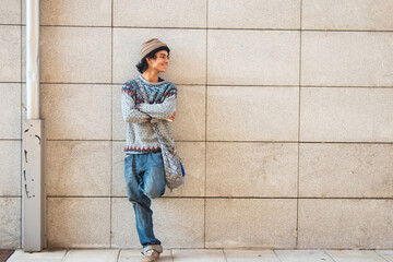 urban young man posing on the wall