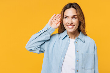 Young curious nosy smiling woman she wears blue shirt white t-shirt casual clothes try to hear you...
