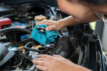 The young woman is opening cooling water, Check open radiator cap.